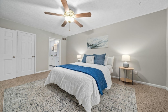 carpeted bedroom with ceiling fan, connected bathroom, and a textured ceiling