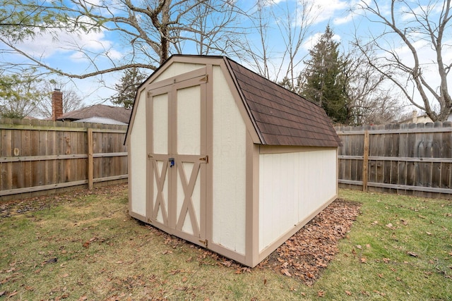 view of outbuilding with a yard