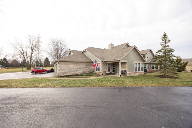 view of front of property featuring a garage and a front lawn