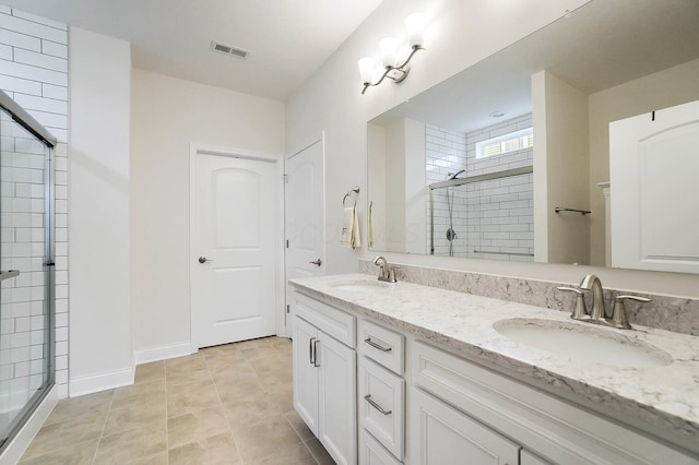 bathroom with vanity, tile patterned flooring, and walk in shower