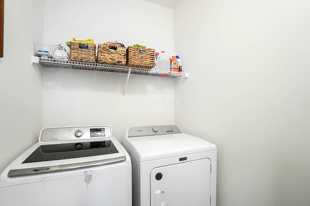 laundry room featuring washing machine and clothes dryer