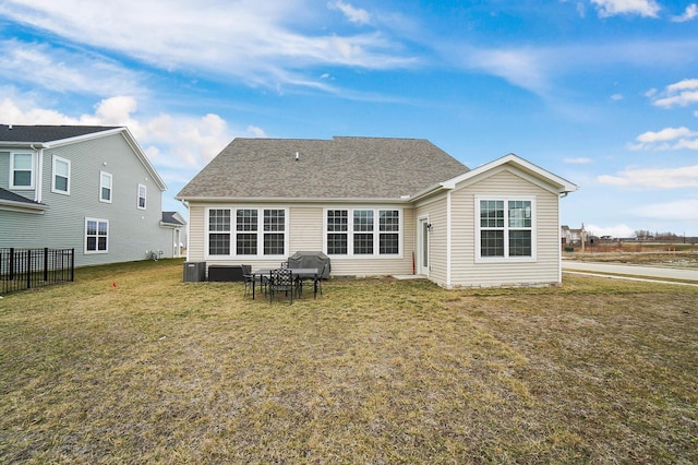 rear view of property with a lawn