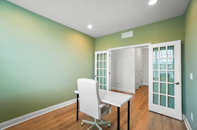 office area featuring french doors and light hardwood / wood-style floors