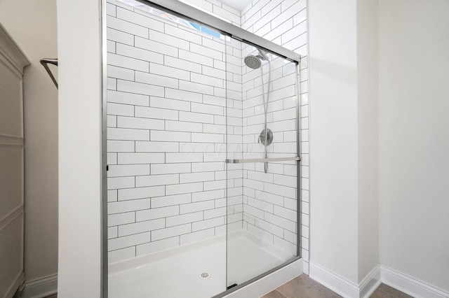 bathroom featuring tile patterned flooring and walk in shower