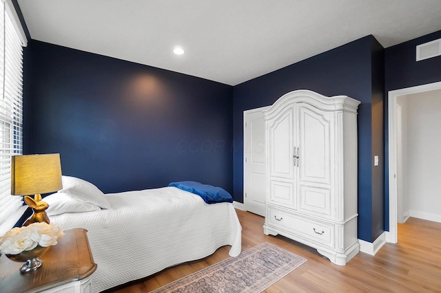 bedroom with hardwood / wood-style flooring