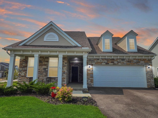 3767 Park St, Grove City, OH 43123 - view of front of home with driveway, an attached garage, stone siding, a porch, and a shingled roof