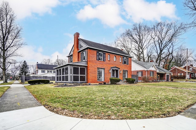 view of side of home featuring a yard and a sunroom