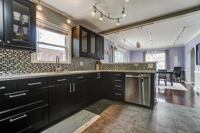 kitchen with rail lighting, sink, decorative light fixtures, dishwasher, and decorative backsplash