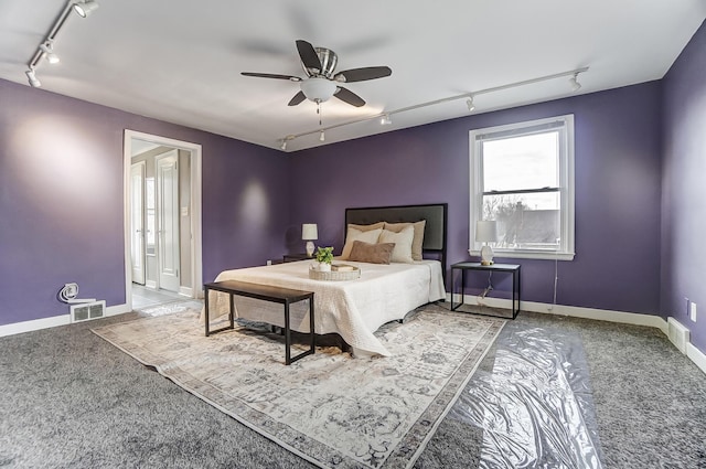 carpeted bedroom with track lighting and ceiling fan