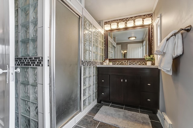 bathroom with ornamental molding, vanity, tile patterned flooring, and a shower with door