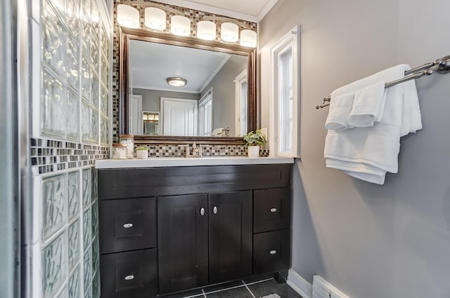 bathroom with tile patterned flooring, crown molding, and vanity