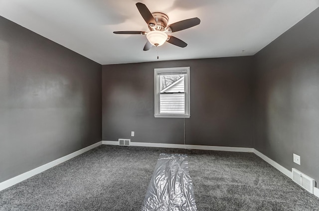 carpeted spare room featuring ceiling fan