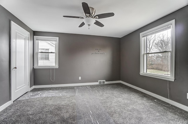 spare room featuring ceiling fan and carpet flooring