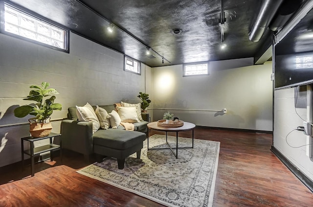 interior space with dark hardwood / wood-style flooring and rail lighting