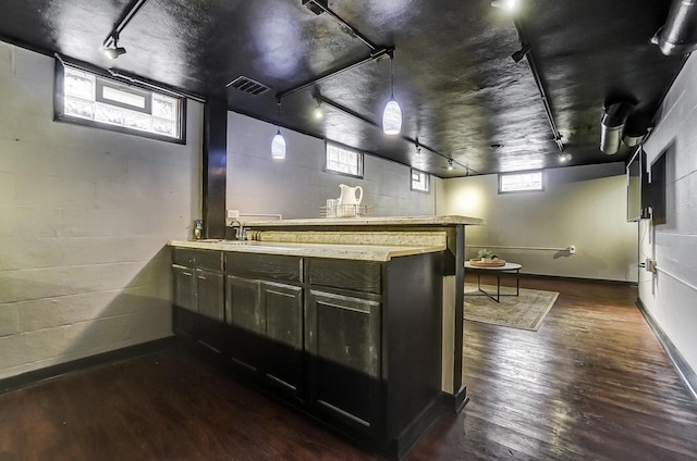 interior space featuring sink, dark wood-type flooring, and track lighting