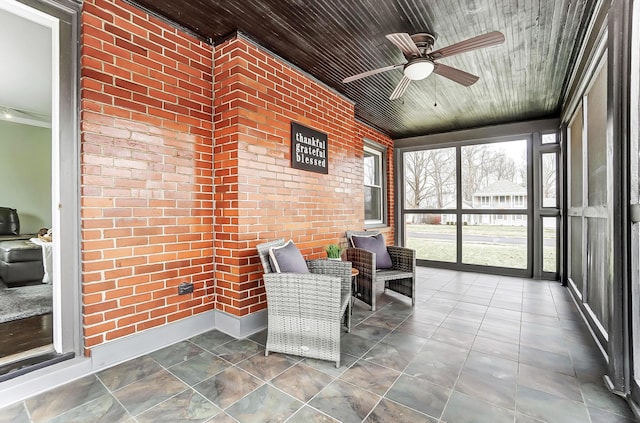 sunroom / solarium featuring wooden ceiling and ceiling fan