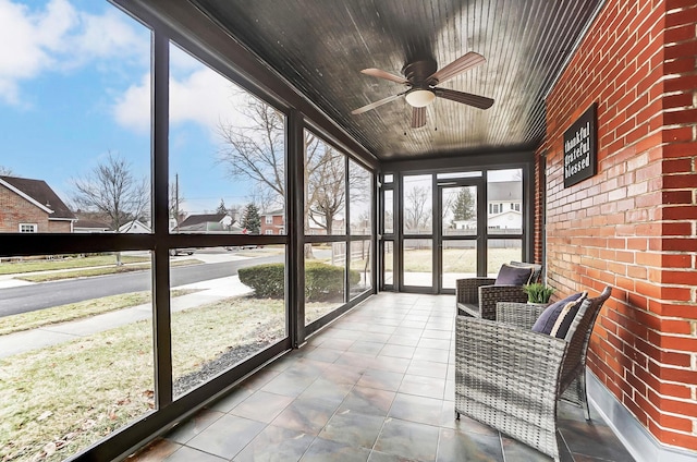 sunroom / solarium featuring ceiling fan and wooden ceiling