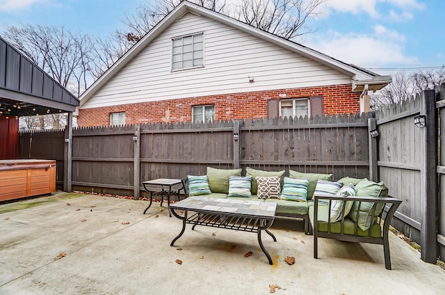 view of patio / terrace with outdoor lounge area and a hot tub