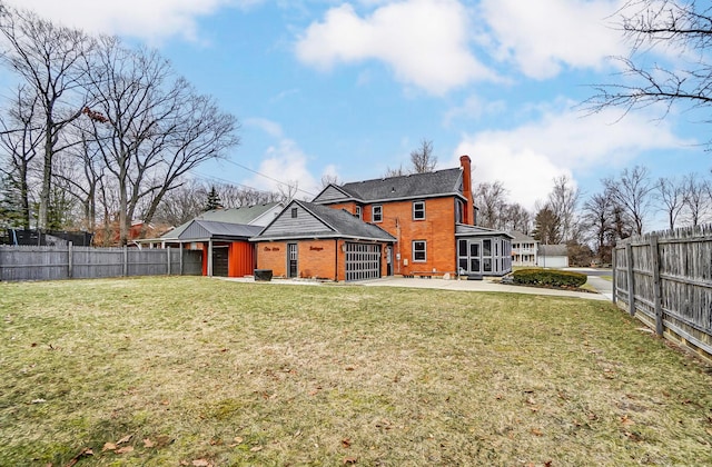 rear view of house with a yard and a patio area