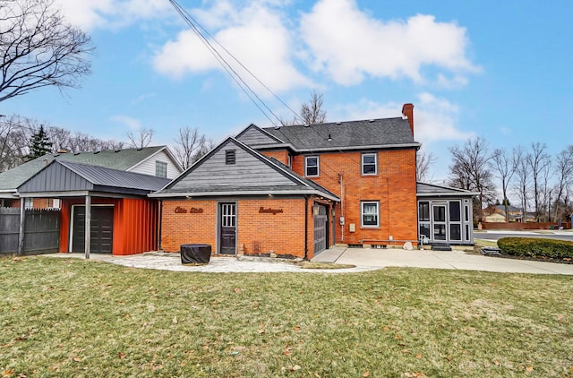 rear view of house with a garage and a lawn