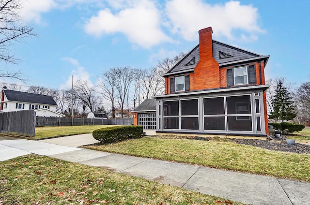 view of side of home featuring a lawn and a sunroom