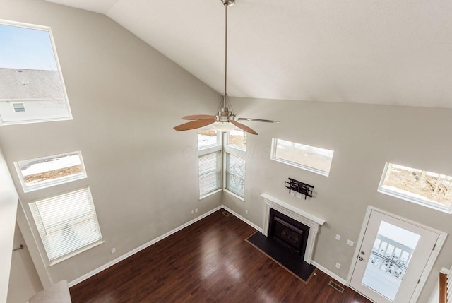 unfurnished living room featuring dark wood-type flooring, a fireplace, visible vents, and baseboards