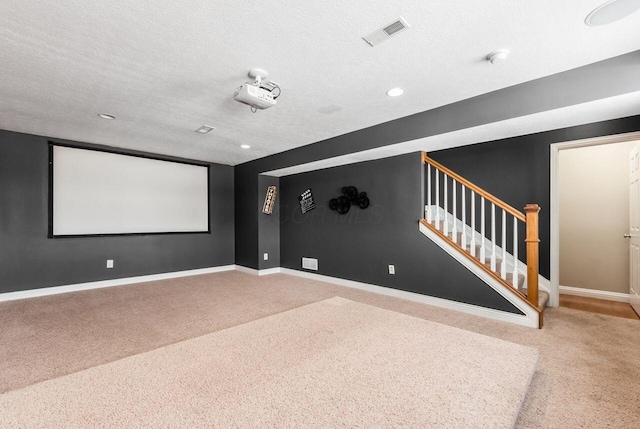 carpeted home theater with a textured ceiling, recessed lighting, visible vents, and baseboards