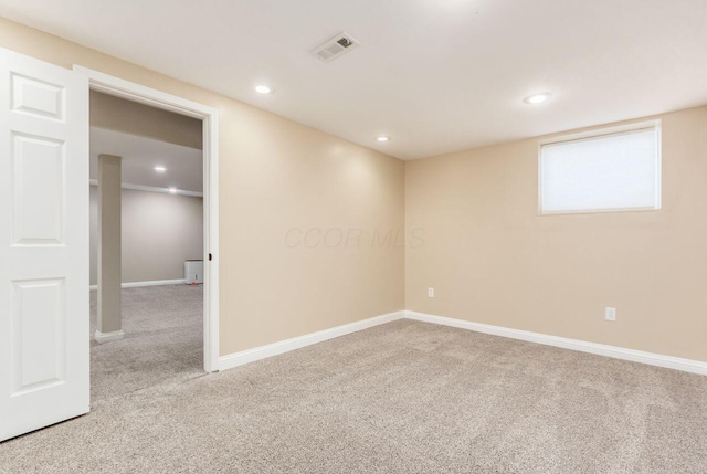 unfurnished room featuring recessed lighting, light colored carpet, visible vents, and baseboards