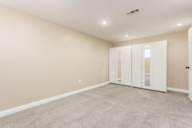 unfurnished bedroom featuring carpet floors, baseboards, visible vents, and recessed lighting