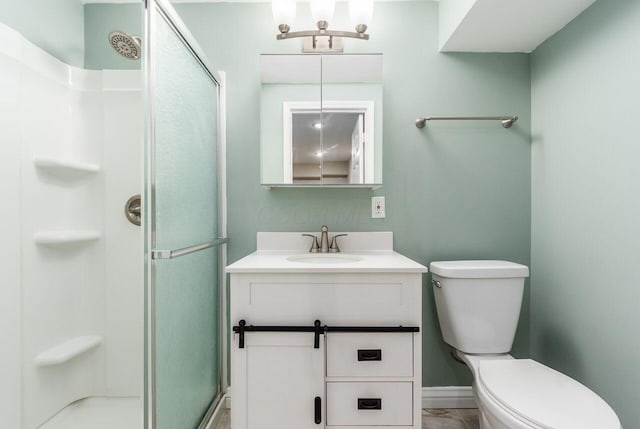 bathroom featuring vanity, toilet, and an enclosed shower