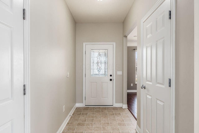 entryway featuring baseboards