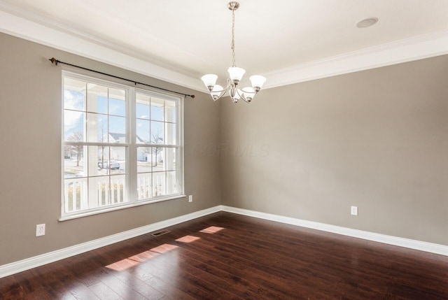 spare room with dark wood-style flooring, visible vents, plenty of natural light, and baseboards