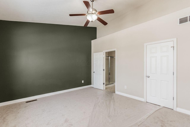 unfurnished bedroom featuring light carpet, baseboards, and visible vents