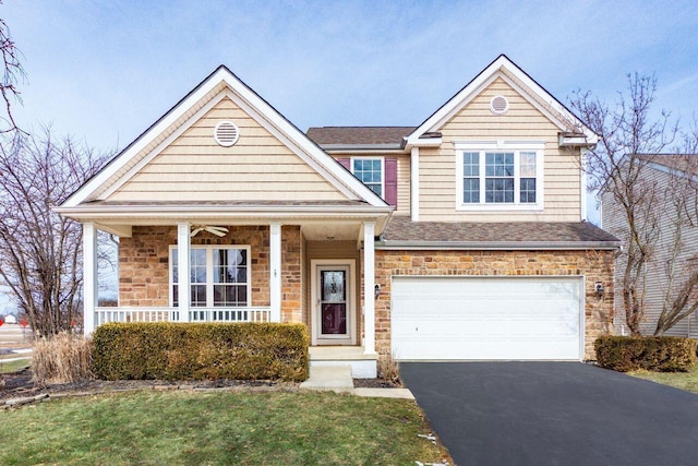 traditional home featuring a garage, stone siding, aphalt driveway, roof with shingles, and covered porch