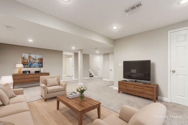 living room with light colored carpet, recessed lighting, visible vents, baseboards, and stairs