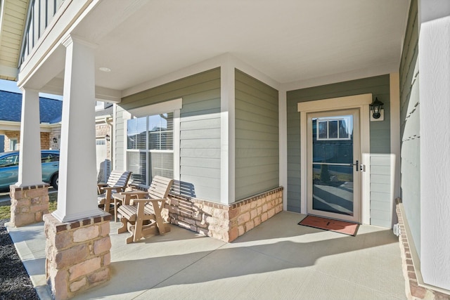 view of exterior entry with covered porch