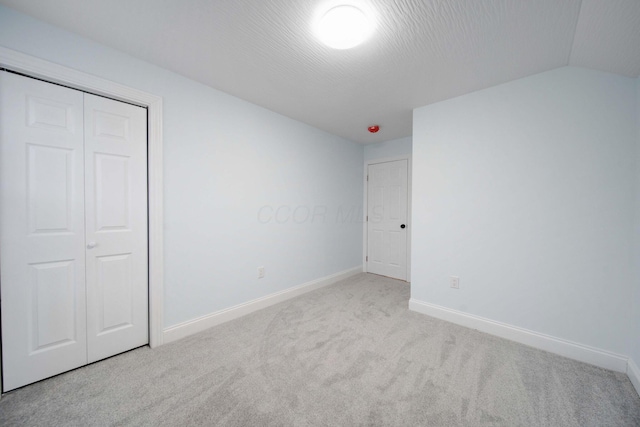 4874 Ridge St, Columbus, OH 43207 - unfurnished bedroom featuring vaulted ceiling, light colored carpet, and a closet