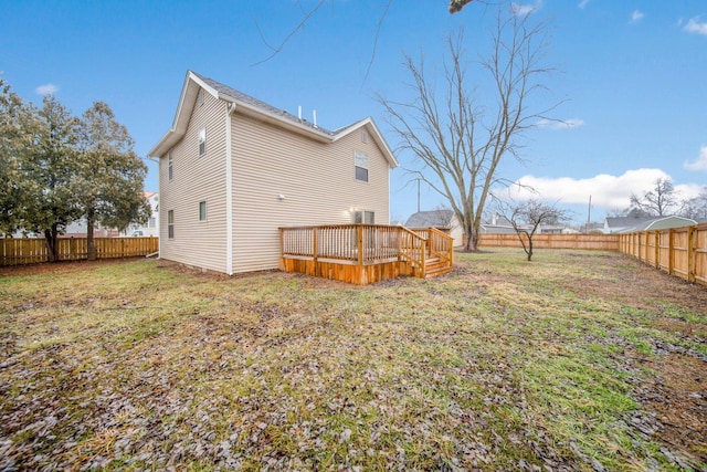 4874 Ridge St, Columbus, OH 43207 - rear view of house with a wooden deck and a lawn