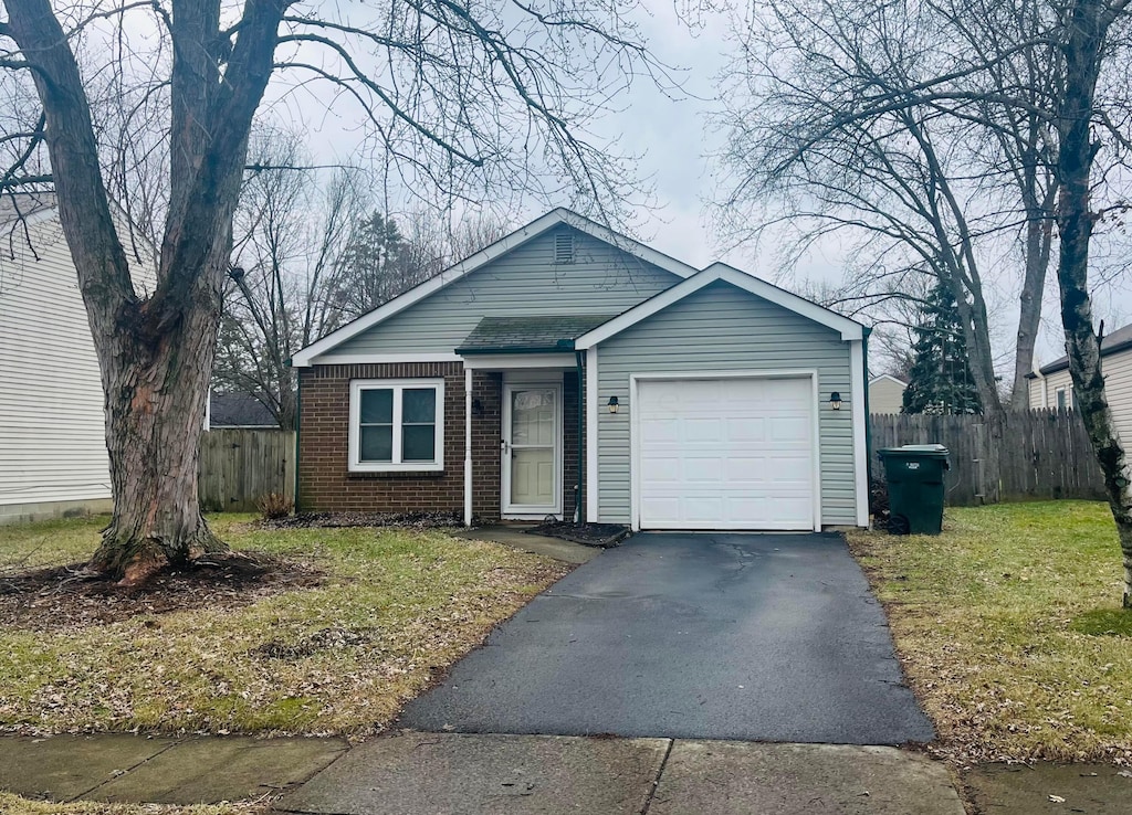 view of front of property featuring a garage and a front lawn