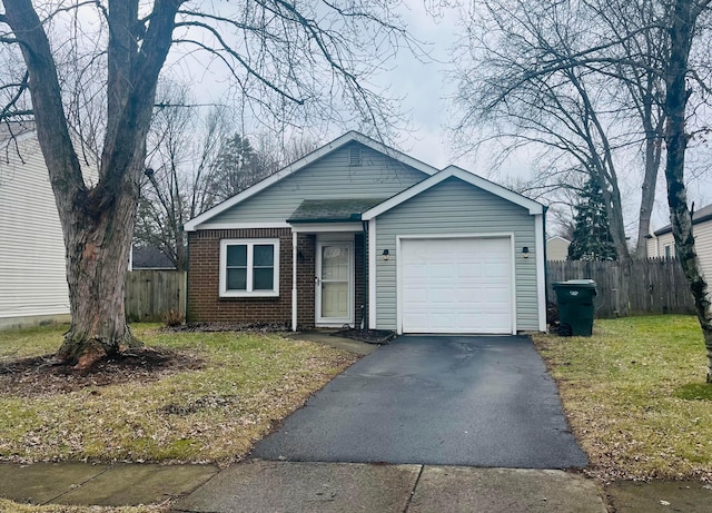 view of front of property featuring a garage and a front lawn