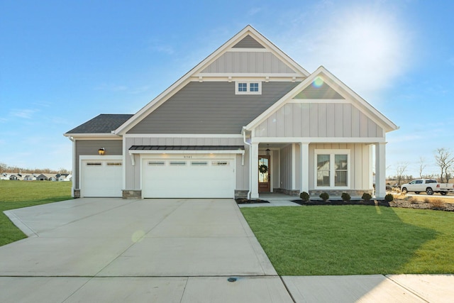 craftsman house featuring a garage and a front yard