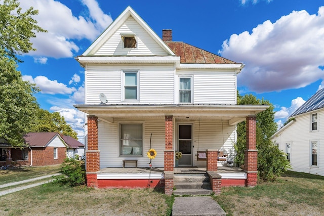 view of front of house with covered porch and a front yard