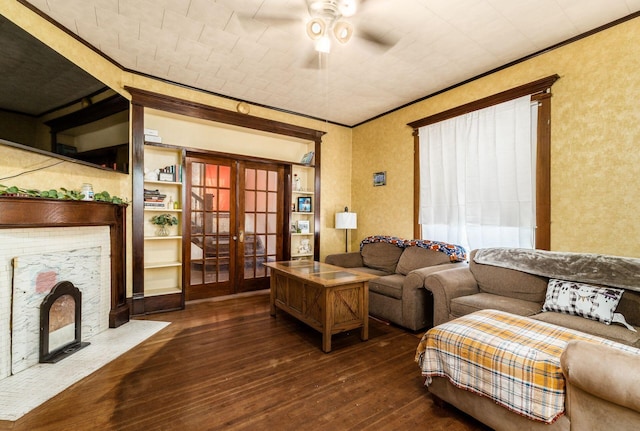 living room with crown molding, dark wood-type flooring, french doors, and ceiling fan