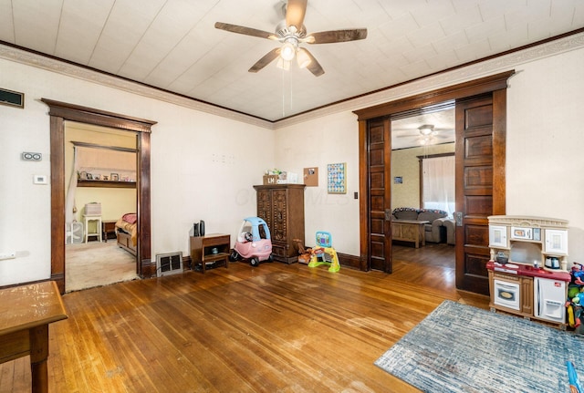 miscellaneous room featuring wood-type flooring, crown molding, and ceiling fan