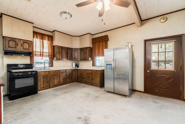 kitchen with plenty of natural light, black range with gas stovetop, light carpet, and stainless steel fridge