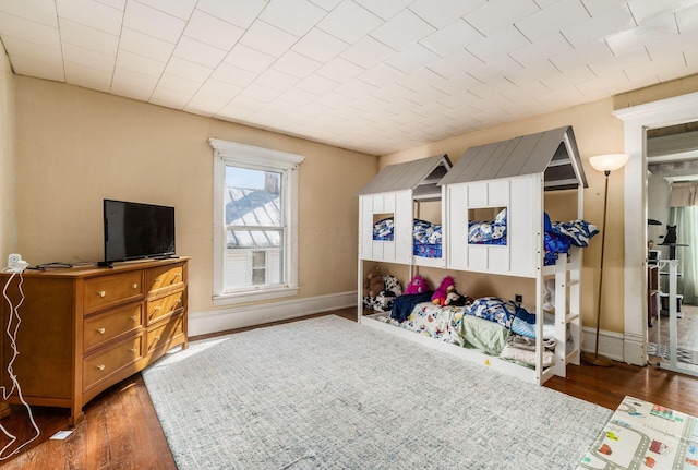 bedroom with dark hardwood / wood-style floors