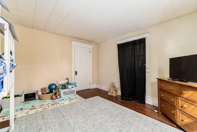 bedroom featuring dark wood-type flooring