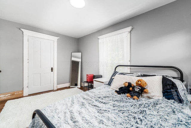 bedroom with hardwood / wood-style flooring