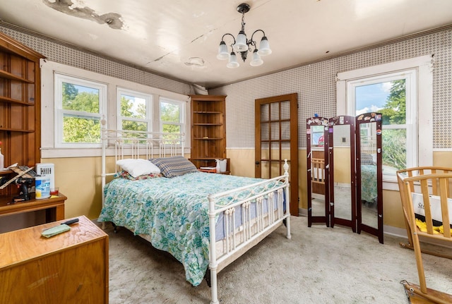 bedroom featuring carpet flooring and a chandelier