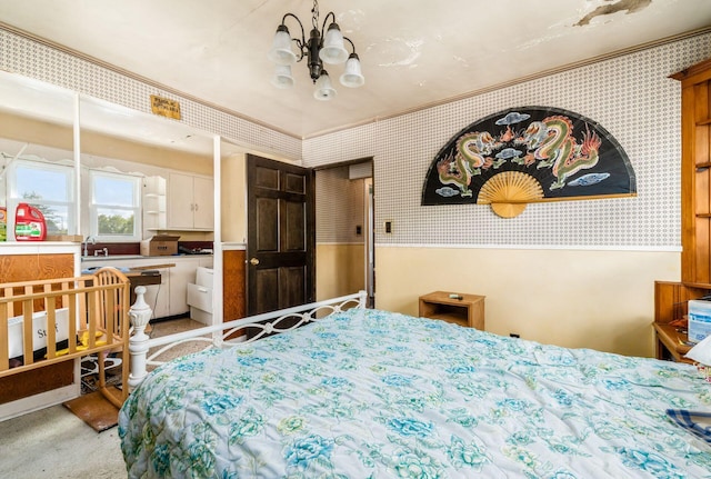 bedroom with a chandelier and sink